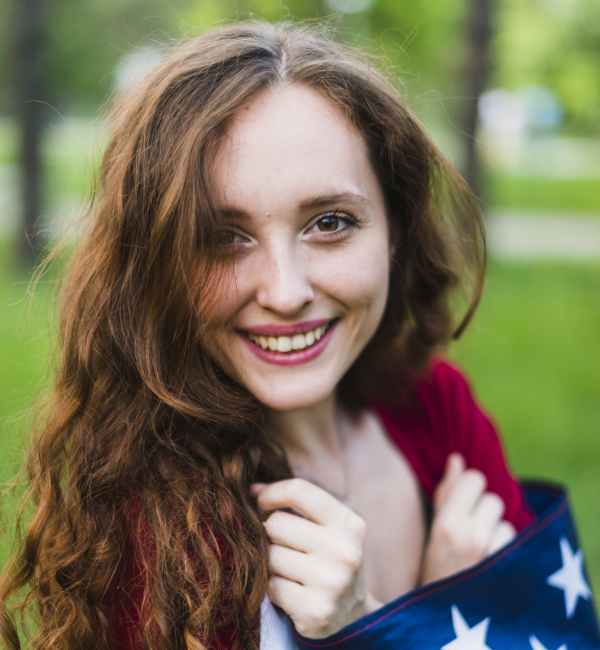 smiling-girl-with-american-flag-nature